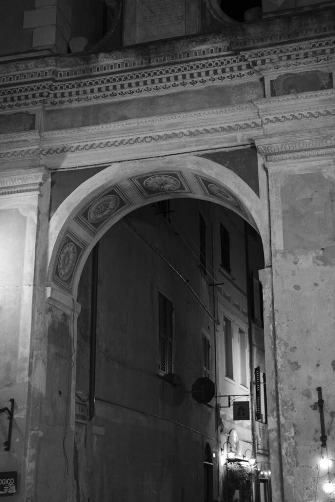 pexels photo 31682076 Black and white photo of a classic Italian archway by night.